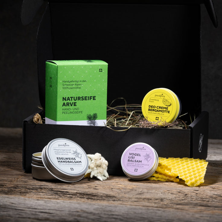 Puralpina gift set in a black box with natural Swiss pine soap, bergamot deodorant cream, edelweiss hand balm and bird ivy balm